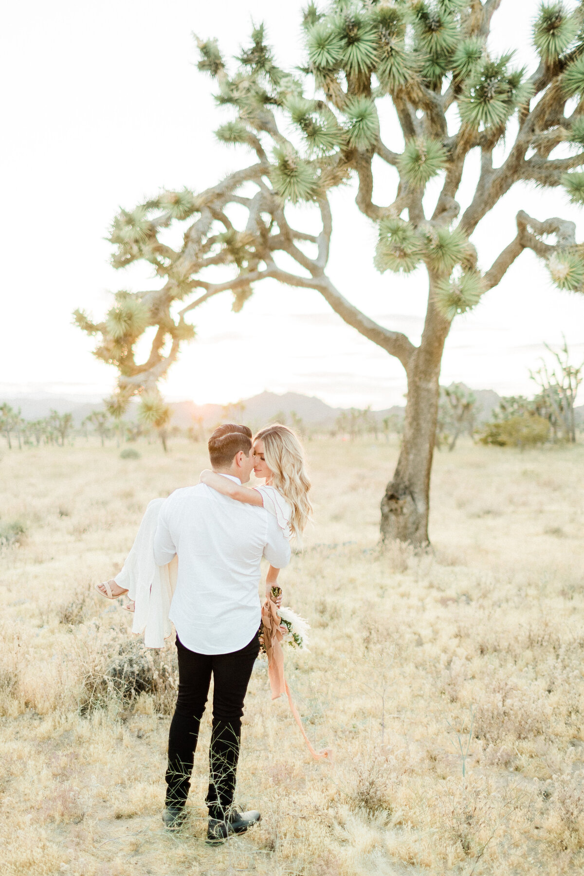 Groom waiting beneath a Joshua tree
