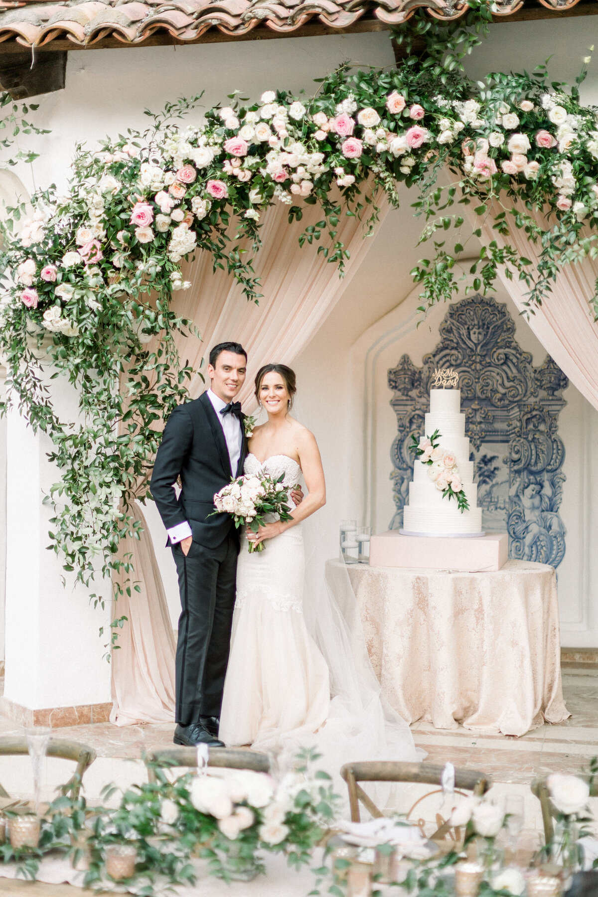 Bride and groom at a rose-covered doorway