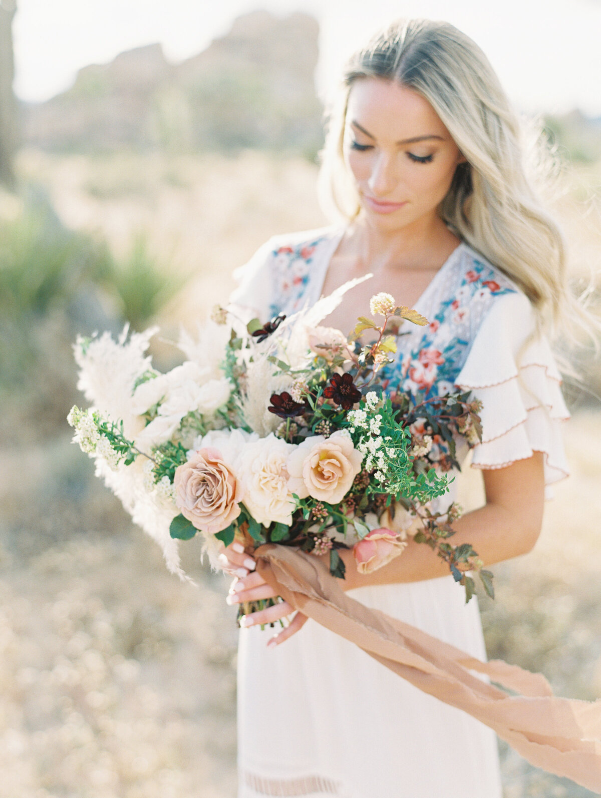 Bride with a loose garden bouquet in soft light