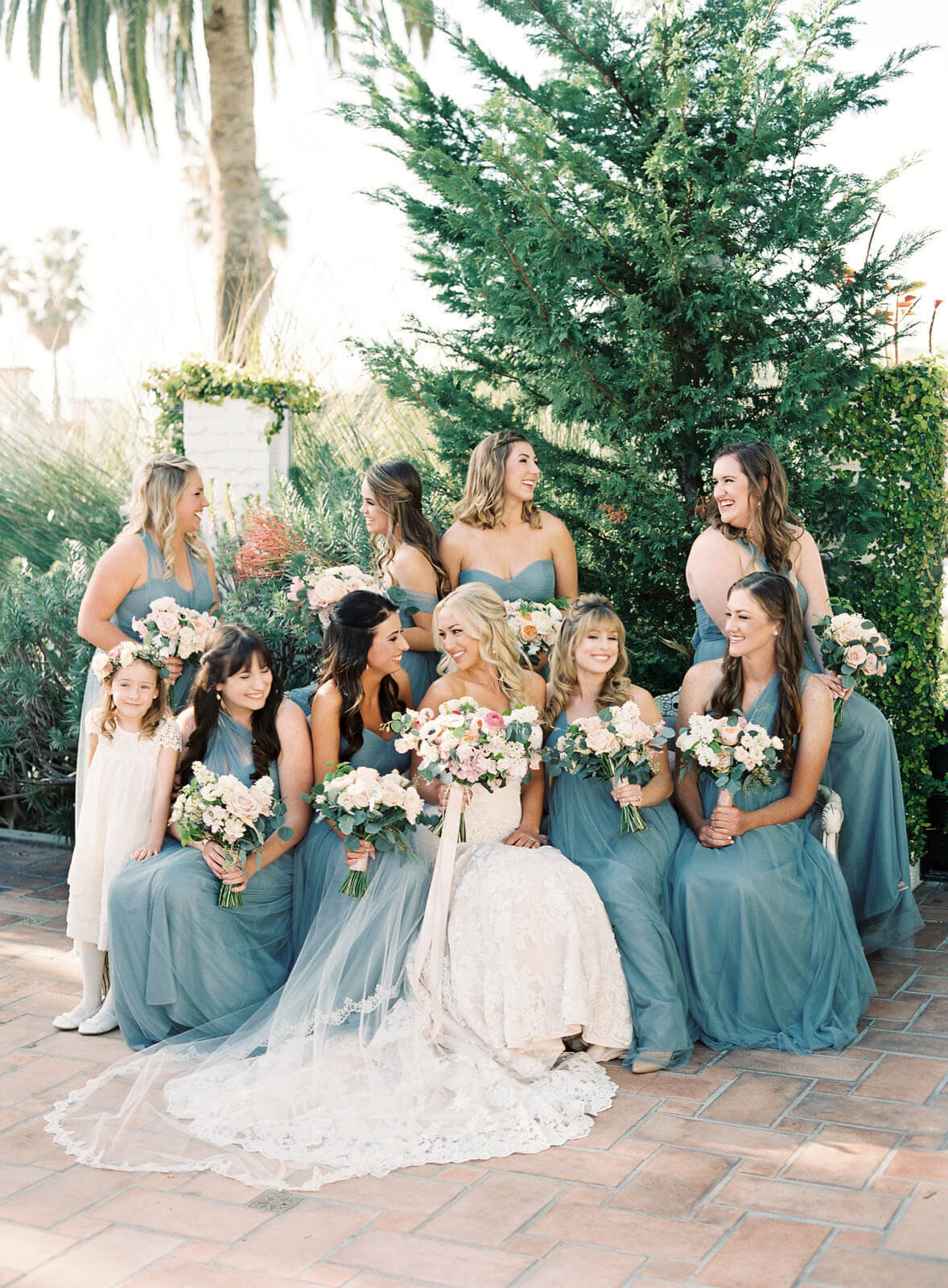 Bridesmaids in dusty blue with white bouquets