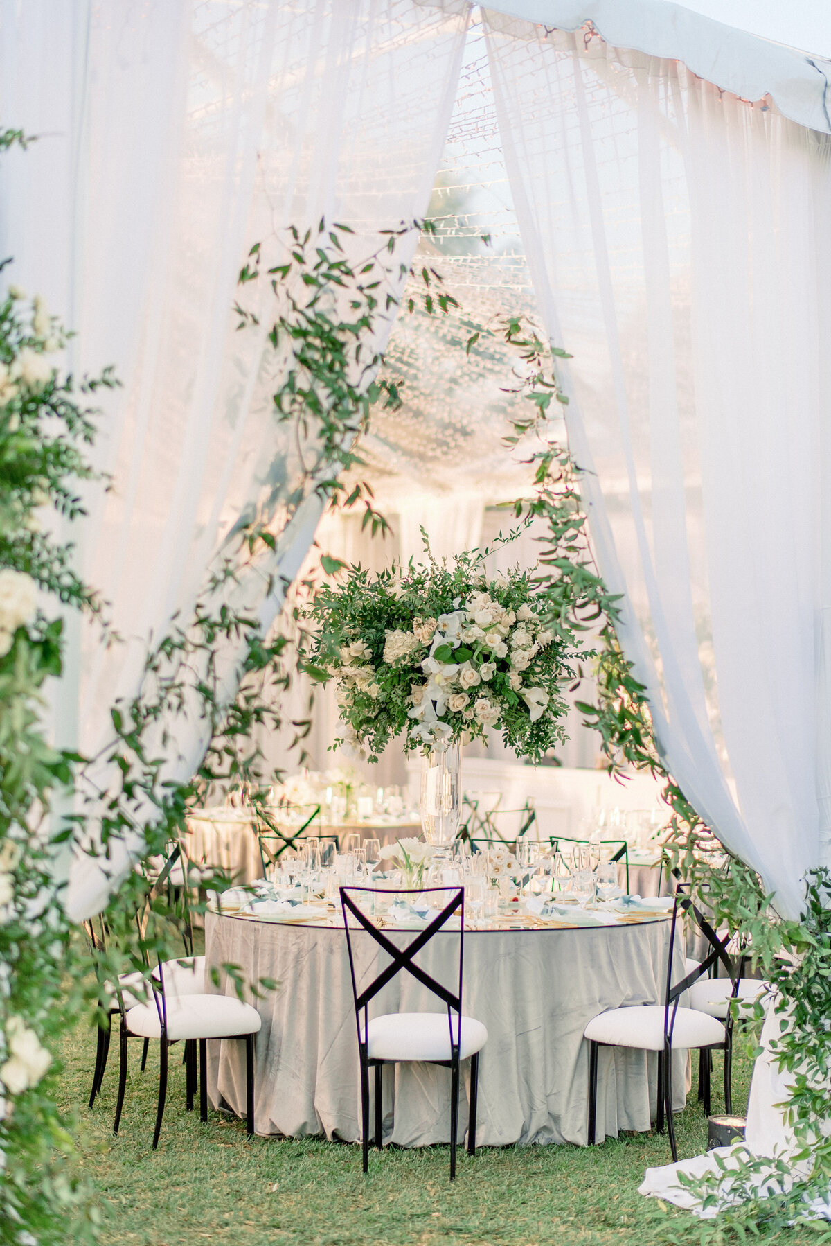 Sweetheart table beneath a floral installation