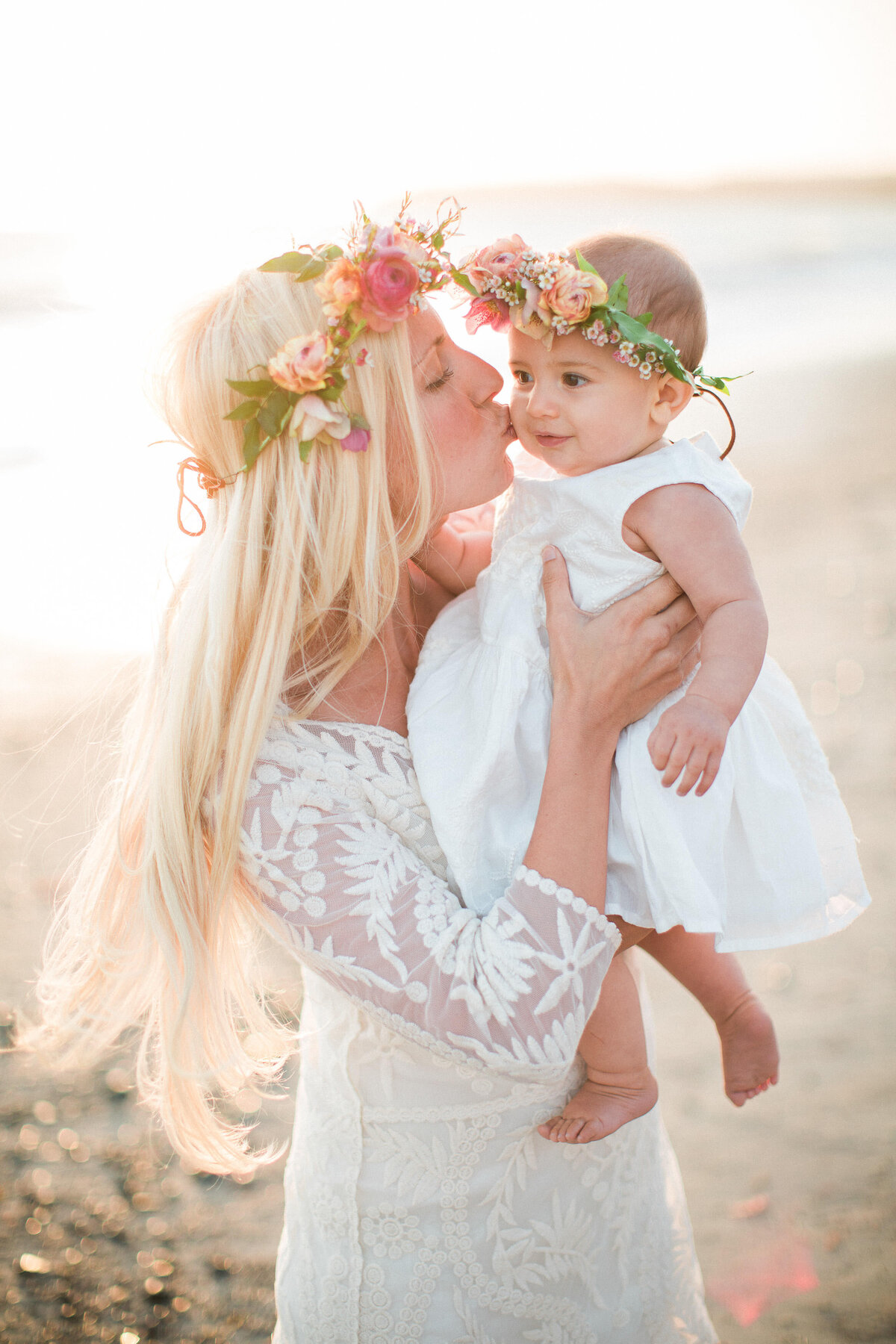 Bride twirling with a flower-crowned little girl