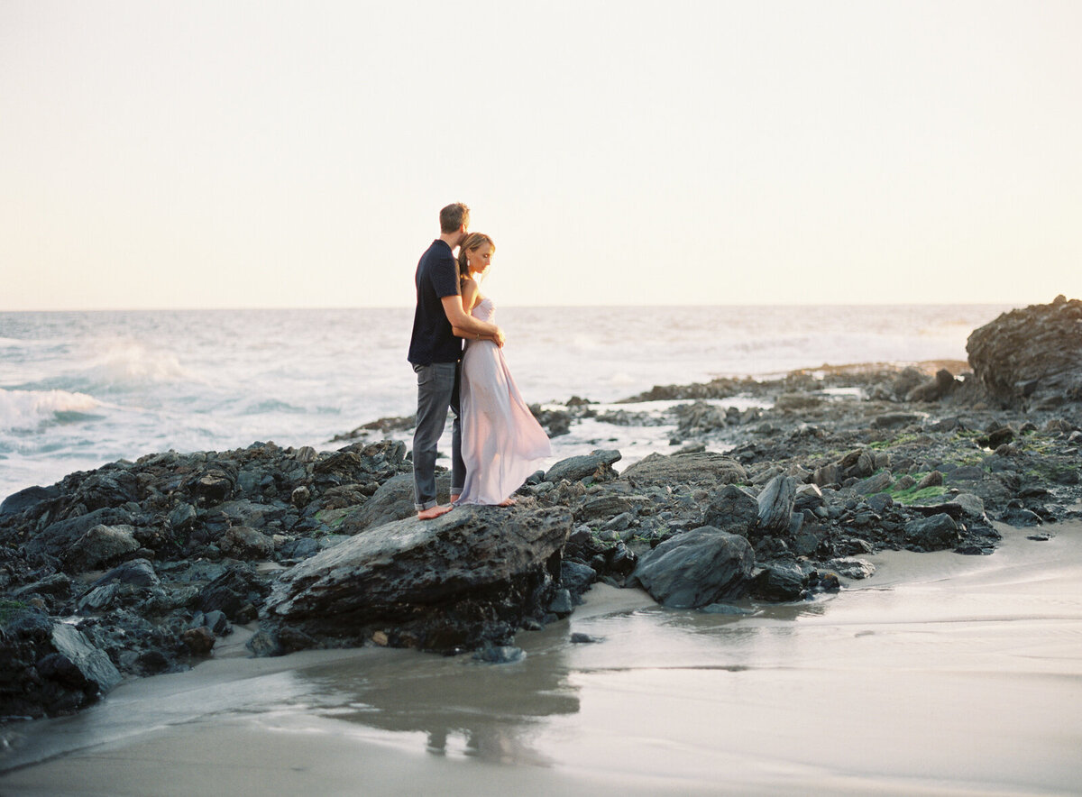 Couple on the tide rocks at dusk