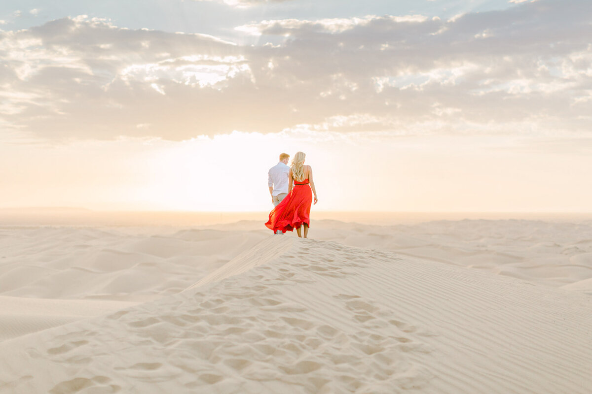A red gown on the dunes at sunset