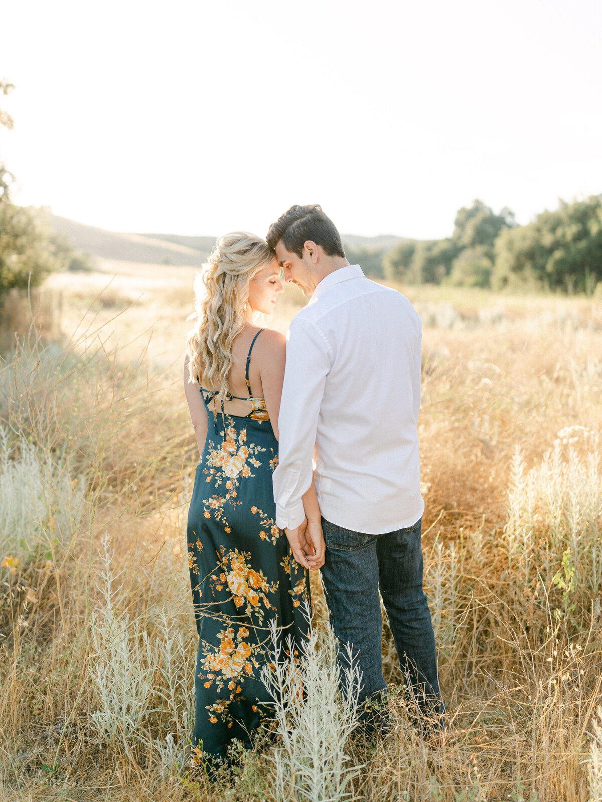 Couple in the tall grass above the coast