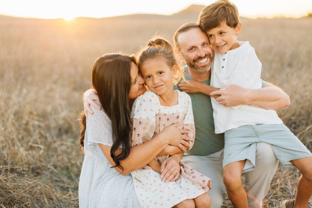 The Hickman family laughing together in the field