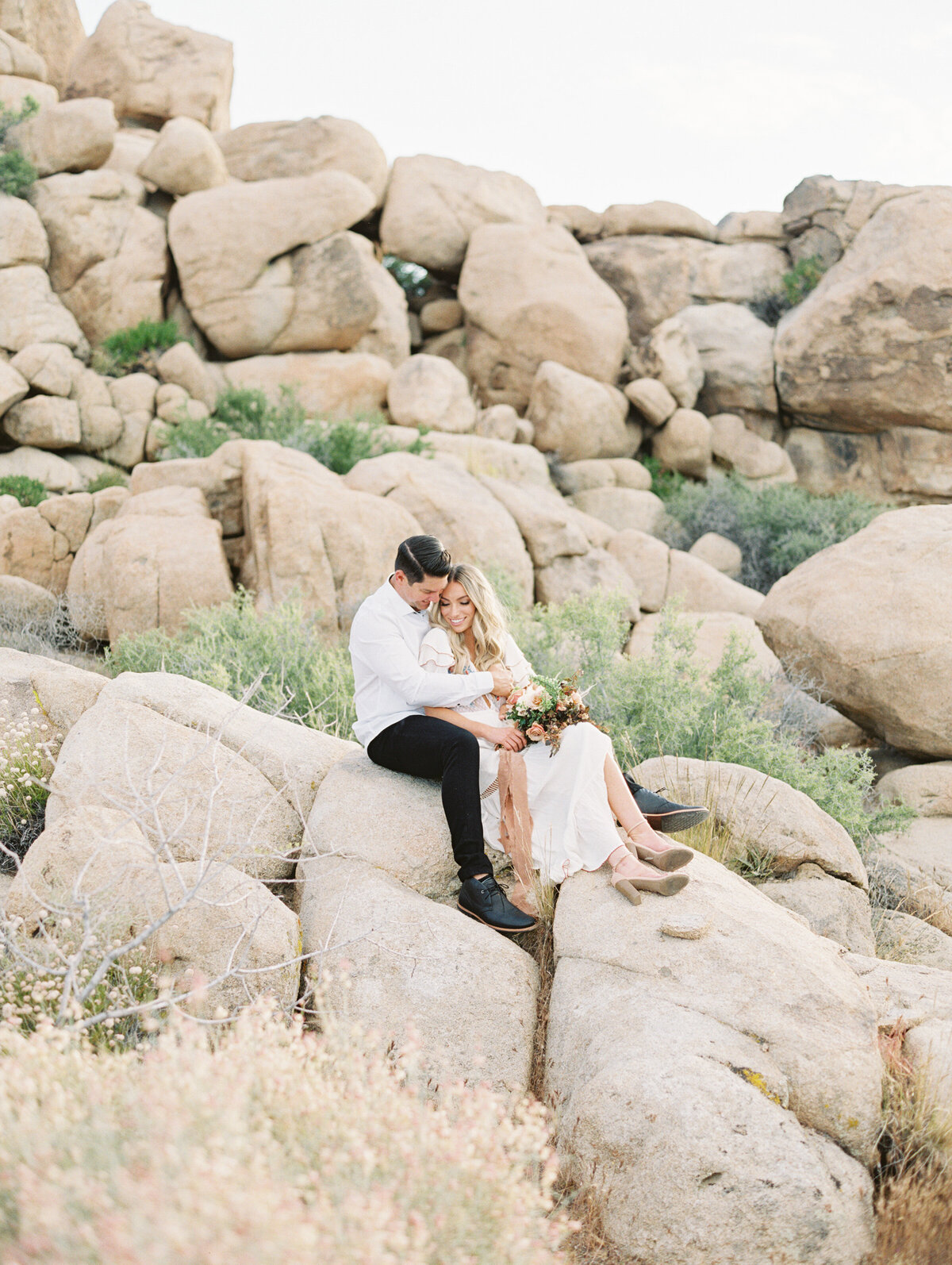 Couple embracing on the shore at golden hour