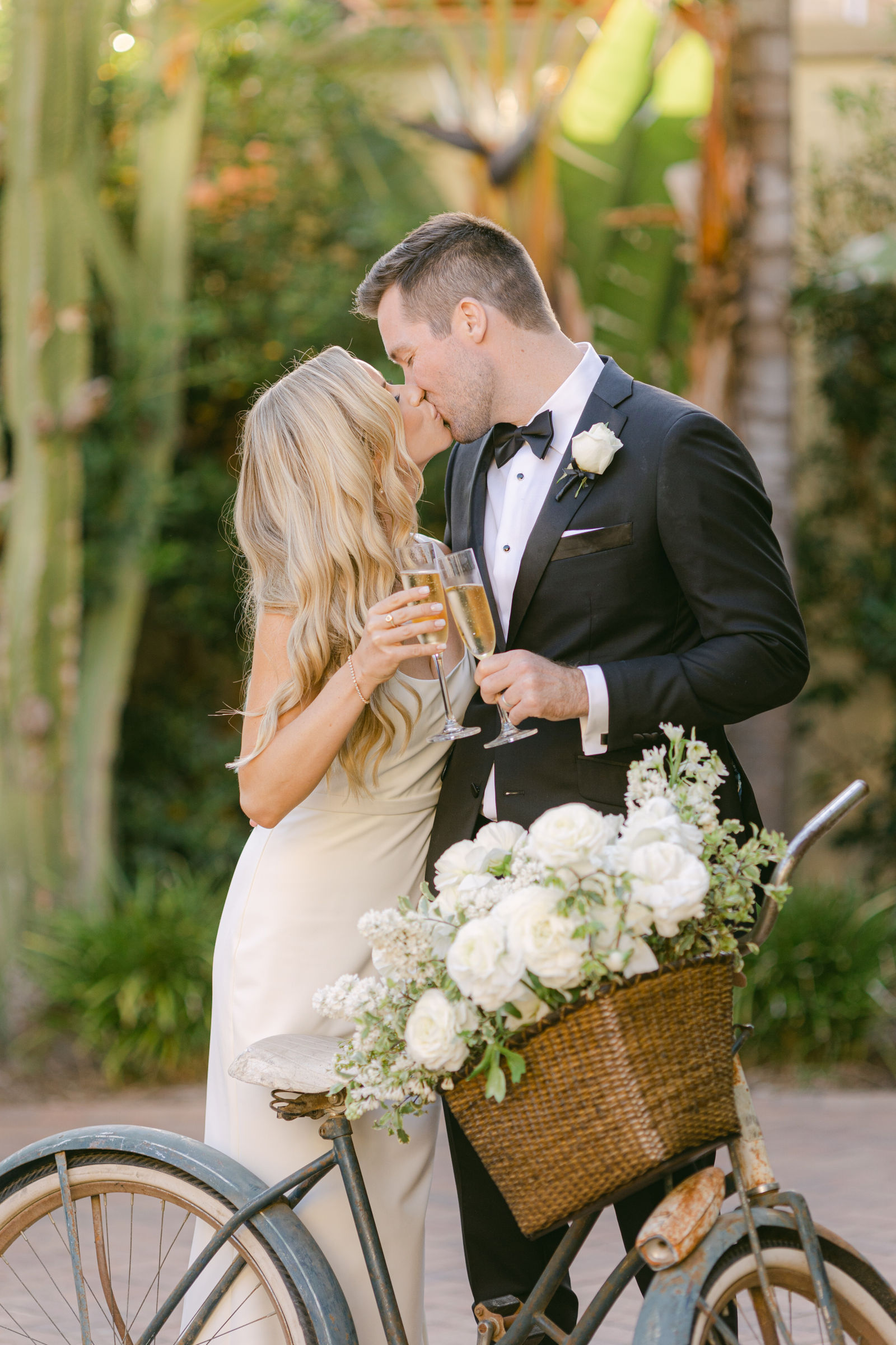 A kiss beside the bicycle, its basket full of peonies