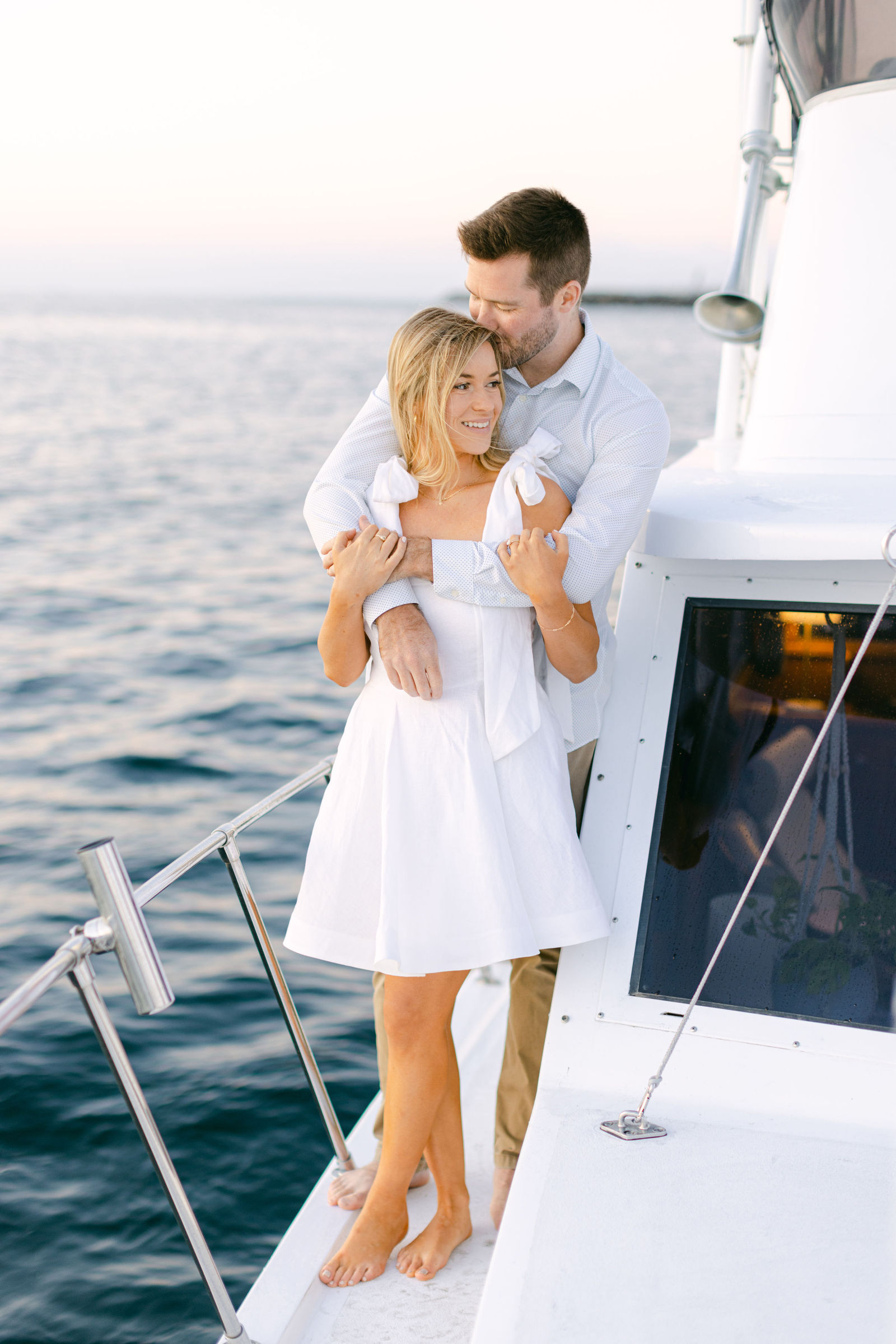 On the boat at dusk, her hair in the wind