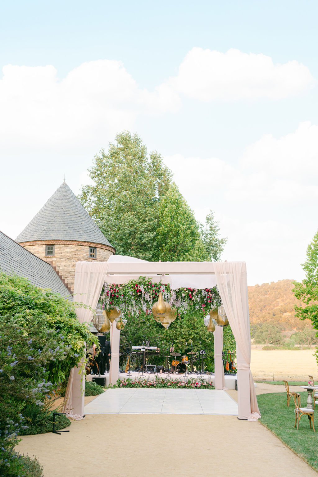 Draped cabana with brass lanterns opening onto the dance floor