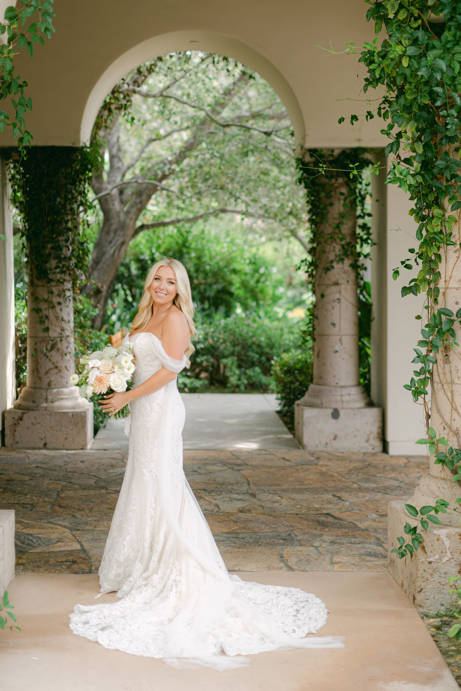 The bride in the vine-covered arched loggia at Shady Canyon Golf Club
