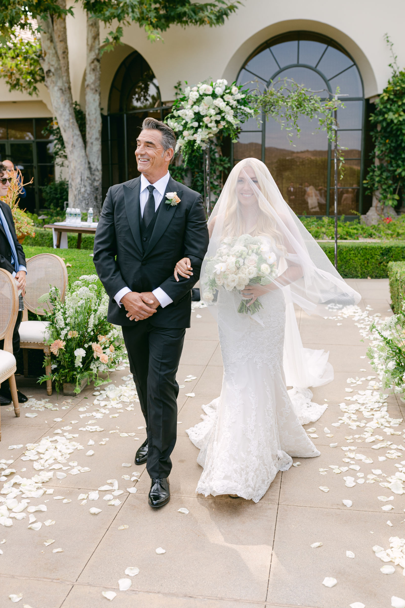 Her father walking her up the petal aisle at Shady Canyon Golf Club