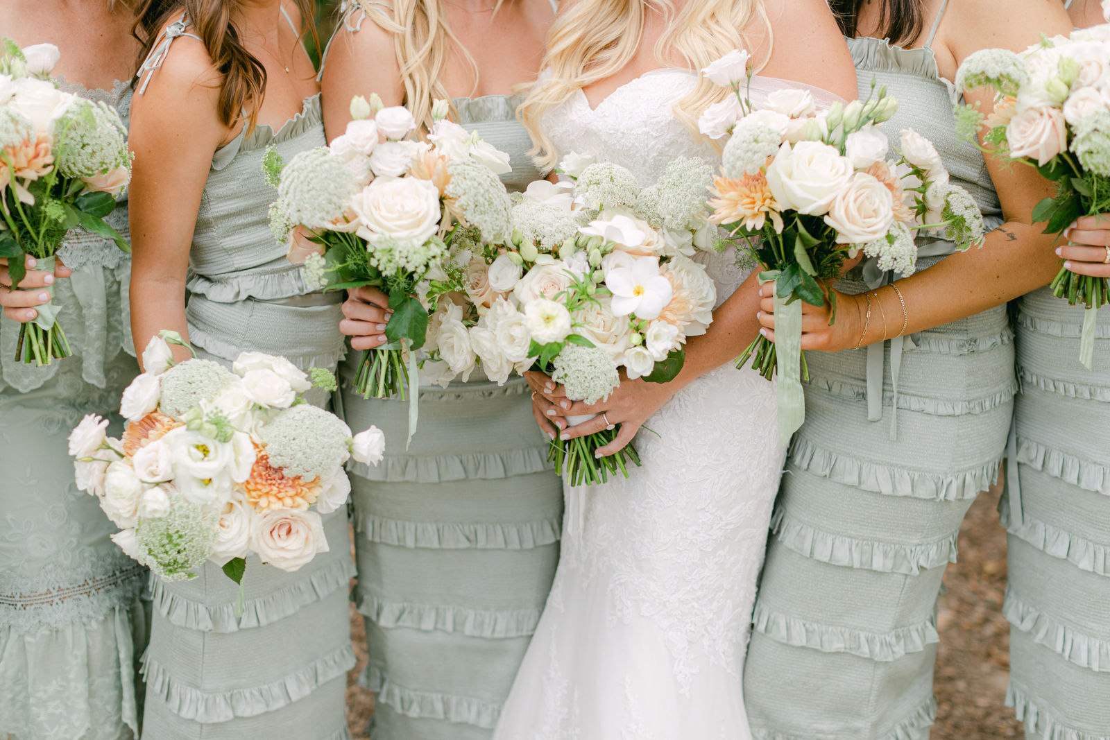 The bridesmaids' bouquets of white roses, dahlias and ranunculus