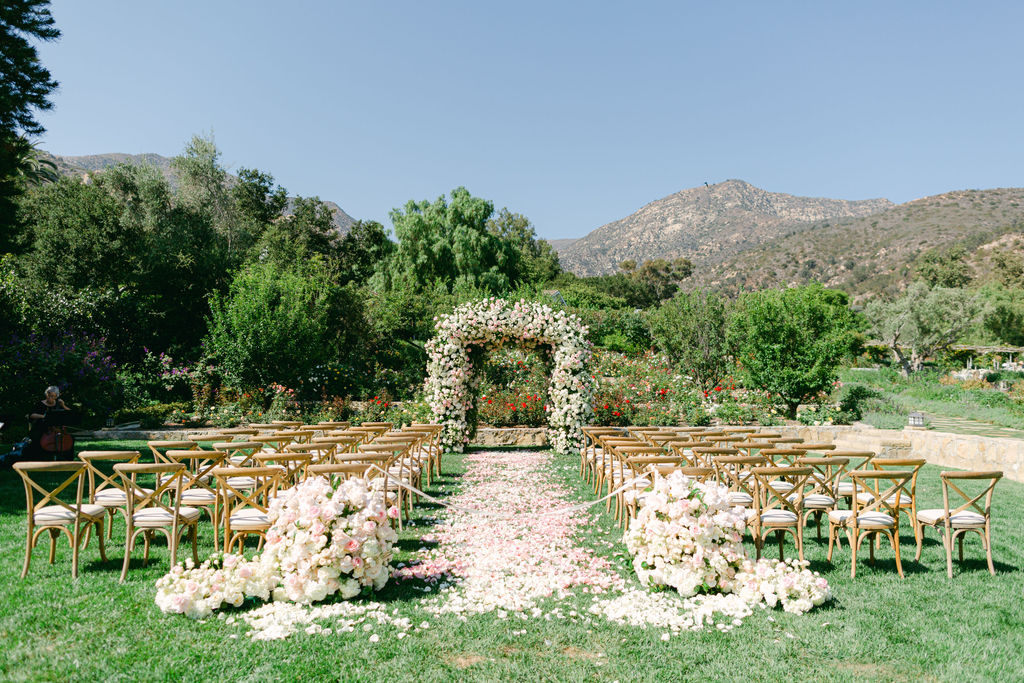 The rose garden ceremony at San Ysidro Ranch, petal aisle and mountains beyond
