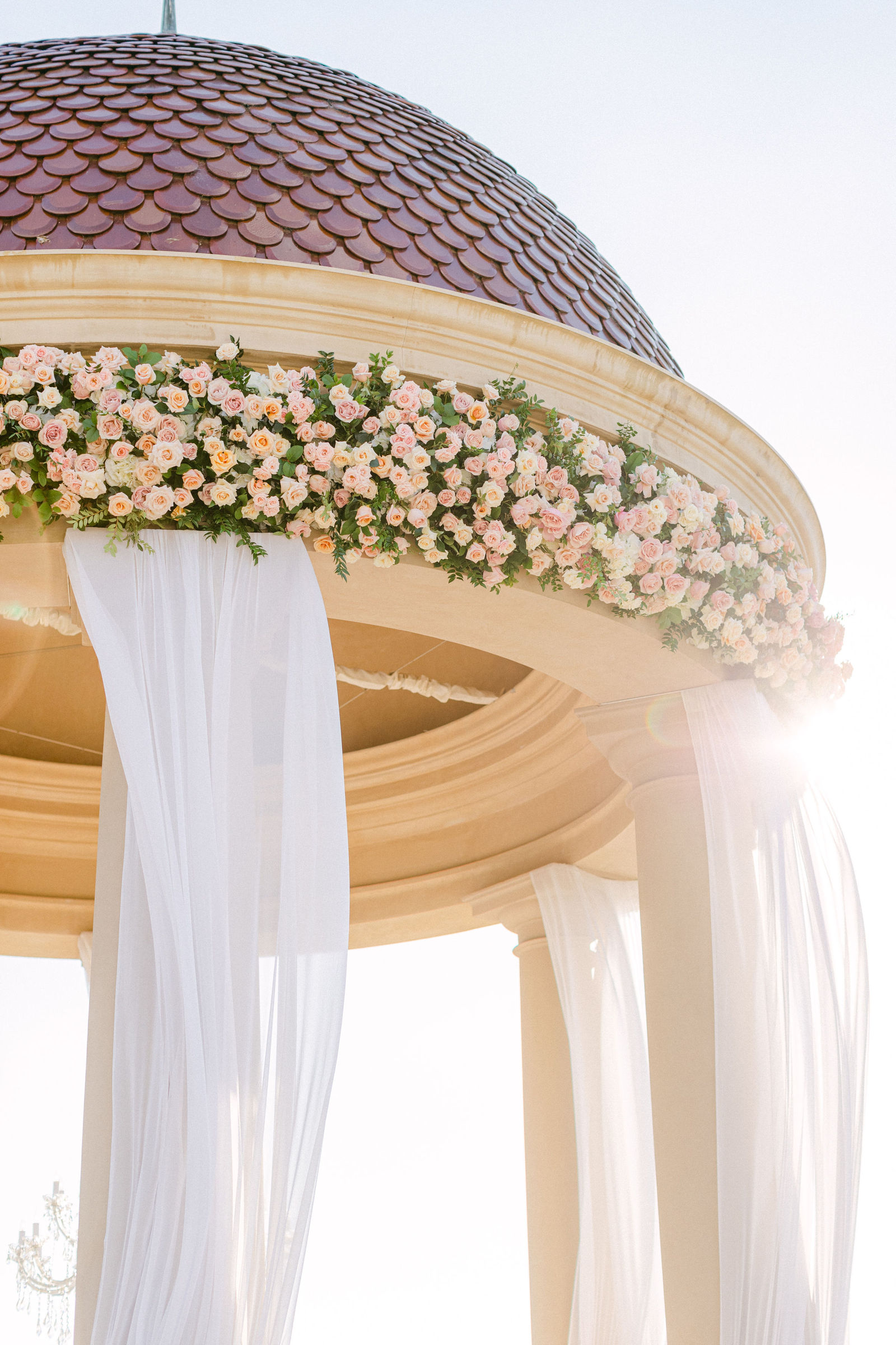Blush roses banding the rotunda dome, white drapery beneath